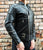 An 80's Metal 'Blade' black leather jacket with a mandarin collar, shoulder and elbow padding, silver metal zippers and a red quilted lining.