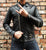 An 80's Metal 'Blade' black leather jacket with a mandarin collar, shoulder and elbow padding, silver metal zippers and a red quilted lining.