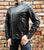 An 80's Metal 'Blade' black leather jacket with a mandarin collar, shoulder and elbow padding, silver metal zippers and a red quilted lining.