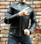 An 80's Metal 'Blade' black leather jacket with a mandarin collar, shoulder and elbow padding, silver metal zippers and a red quilted lining.