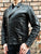An 80's Metal 'Blade' black leather jacket with a mandarin collar, shoulder and elbow padding, silver metal zippers and a red quilted lining.