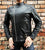 An 80's Metal 'Blade' black leather jacket with a mandarin collar, shoulder and elbow padding, silver metal zippers and a red quilted lining.