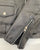 A close up of the zipped cuff on this classic black leather jacket with epaulets on the shoulders, high collar, zipped cuffs, adjustable belt, multiple pockets and a silver satin effect lining.