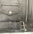 A close up of the belt on this classic black leather jacket with epaulets on the shoulders, high collar, zipped cuffs, adjustable belt, multiple pockets and a silver satin effect lining.