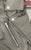 A close up of the collar on this classic black leather jacket with epaulets on the shoulders, high collar, zipped cuffs, adjustable belt, multiple pockets and a silver satin effect lining.