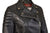 Close up of the collar on a black leather jacket with padded diamond stitching across the shoulders and lower back, featuring zipped cuffs and a high collar.