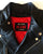 An 80's Metal 'Blade' black leather jacket with a mandarin collar, shoulder and elbow padding, silver metal zippers and a red quilted lining.