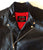 An 80's Metal 'Blade' black leather jacket with a mandarin collar, shoulder and elbow padding, silver metal zippers and a red quilted lining.