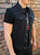 A black denim cut-off battle-jacket featuring ripped & stitched arm holes, chest and side pockets and a collared neckline.