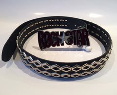 An 80's Glam black leather studded Belt featuring a shiny red and black 'ROCKSTAR' buckle with a silver star.