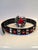 An 80's Metal black leather belt featuring a red star and silver stud pattern with a red and silver star buckle.