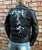 A metalworks leather jacket featuring Ozzy Osbourne 'Ordinary Man' on the back, with epaulets, multiple pockets, adjustable belt and high quality zips.  
