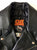 Close up of the inside neck patch on a metalworks leather jacket featuring Ozzy Osbourne 'Ordinary Man' on the back, with epaulets, multiple pockets, adjustable belt and high quality zips.  