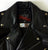 A close up of the inside neck patch on a metalworks leather jacket featuring Judas Priest 'Defenders Of The Faith' on the back, with epaulets, multiple pockets, adjustable belt and high quality zips.  