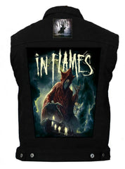 A black denim battlejacket with 'In Flames' band artwork on the back, featuring a figure in a dark setting with flames.